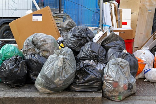 Waste collection trucks operating in South West London streets.